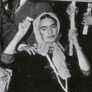Frida Kahlo at Communist protest with fist raised