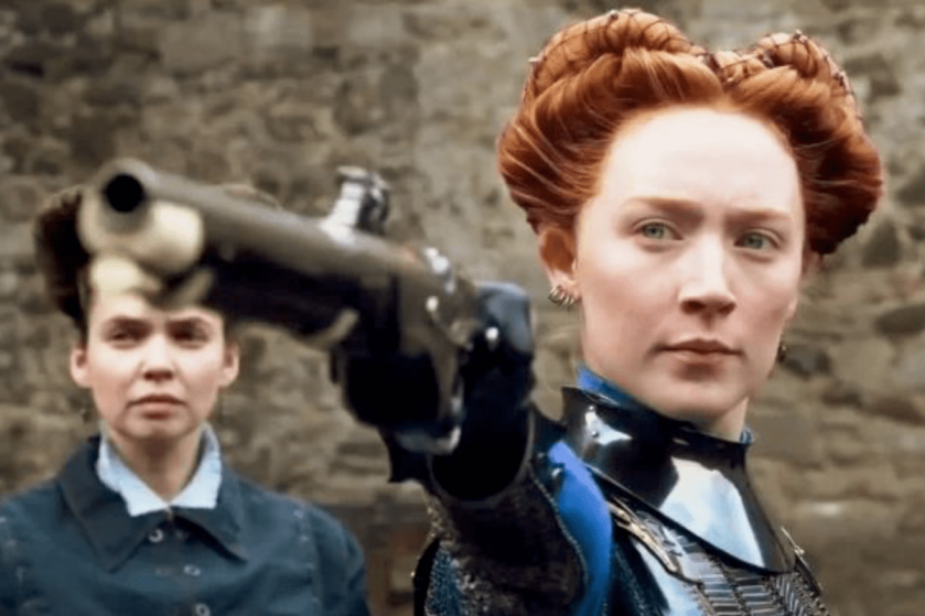 close up of Saoise Ronan as Mary Queen of Scots shooting a gun